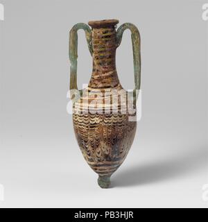 Glas amphoriskos (Parfüm Flasche). Kultur: Griechisch, östlichen Mittelmeer. Abmessungen: H. 5 13/16-in. (14,8 cm). Datum: 2. bis Mitte 1. Jahrhundert v. Chr.. Durchscheinende Licht blau; Griffe und Base-Knopf in Transluzent blau grün; Wanderwege in opak weiß und undurchsichtig Gelb. Nach innen geneigte Rim-disk, mit Werkzeugen Gedankenstrich unter; hohe, leicht konkav, zylindrischen Hals, schräge Schulter; längliche piriform Körper; große angewandte Knopf-Base; zwei Griffe in Pads über Schulter angewandt, senkrecht nach oben bis knapp unter Rim gezeichnet, dann auf und ab, um den Hals geschlungen, und unten über Rim Trail Dekoration angebracht. Thi Stockfoto