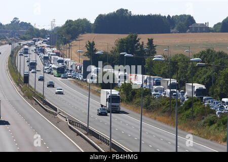 Warteschlangen für den Eurotunnel in Folkestone, Kent, zurück Ausdehnung in Richtung Autobahn M20, die als Fahrgäste mit der Cross-Channel Services wurden Verzögerungen von bis zu fünf Stunden gewarnt, nachdem Klimaanlagen in den Zügen inmitten der heißen Temperaturen ist fehlgeschlagen. Stockfoto