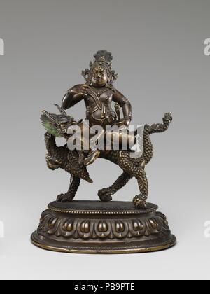 Weiß Jambhala auf einem Drachen. Kultur: die Mongolei. Abmessungen: H. 5 1/4 in. (13,3 cm). Datum: 18. bis 19. Jahrhundert. Obwohl ein Teil der Juwel-Familie geboren, die mit dem Buddha Ratnasambhava, weiß Jambhala stammt aus dem rechten Auge der barmherzigen Bodhisattva Avalokiteshvara geboren worden zu sein. Er ist erkennbar an den Drachen reitet er und seine goldene Schwert, eine Variante der khatvanga Ritual, das Personal, die er in seiner linken Hand hält. Er lindert die Armut leiden und Krankheit und reinigt nonvirtuous karmischen Handlungen. Museum: Metropolitan Museum of Art, New York, USA. Stockfoto