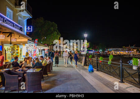 Die erstaunliche Küstenstadt Parga in der Nacht. Touristen und Besucher zu Fuß über der Küste neben der schön geschmückte Geschäfte und Restaurants. Parga Stockfoto