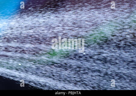 Eine Dusche von Wasser aus einem Gartenschlauch, bevor die vorgeschlagenen Gartenschlauch Verbot in Kraft tritt. Stockfoto