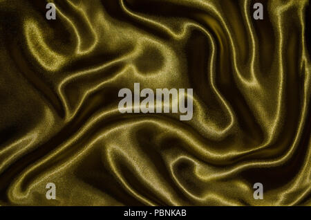 Zusammenfassung Hintergrund durch Gold Stoff, Tapeten und Textur von textilen Gold, Ansicht von Oben und Welle der Streifen Stoff. Stockfoto