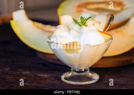 Vanilleeis mit Stücken von frische Melone schließen Stockfoto