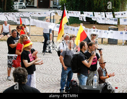 Wiesbaden, Deutschland. 29. Juli, 2018. Rechtsradikale Demonstranten hören den Reden. Rechtsextreme Demonstranten der Hand in Hand-Gegen die Gewalt in unseren Strasen (Hand in Hand - gegen Gewalt auf unseren Straßen) Bewegung statt einer regierungsfeindlichen Kundgebung in Wiesbaden. Dieser Protest war unter dem Vorwand, eine Mahnwache für den Jugendlichen Susanna F, der angeblich von einem Flüchtling in Wiesbaden getötet wurde. Die Kundgebung wurde von mehreren Anti-government Referenten, die forderte, dass die Regierung zum Rücktritt gerichtet. Quelle: Michael Debets/Pacific Press/Alamy leben Nachrichten Stockfoto