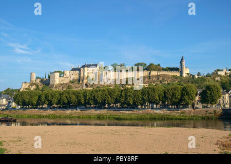 Chinon Schloss befindet sich auf dem Hügel im frühen Herbst morgen Sonnenschein hoch über dem Fluss Vienne, Indre-et-Loire, Frankreich. Der Fluss hat viel weniger Wasser am Ende des Sommers. Stockfoto