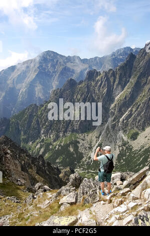 Tatranska Lomnica, Slowakei - 4. August 2013: Im Sommer, der Tourist nimmt Bilder von den Gipfeln der Hohen Tatra, der Ferienort Tatran Stockfoto