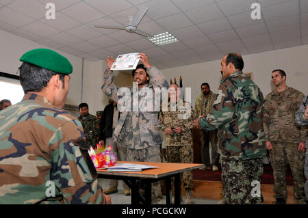 Ein Afghan National Army Soldat zeigt stolz seine Urkunde während einer Abschlussfeier an der Afghan National Army Engineer School in der Nähe von Camp Spann, Dez. 15 statt. Fünfzehn afghanischen Soldaten studierte an der Zeremonie und können jetzt die Explosive Ordnance Disposal Patch und Abzeichen nach Abschluss 22 Wochen Intensivtraining EOD und improvisierte Explosive Vorrichtung Niederlage tragen. Der Ingenieur-Schule ist die einzige in Afghanistan, die die Grundlagen der EOD und IEDD afghanischen nationalen Sicherheitskräfte lehrt. International Security Assistance Force Regional Befehl North unterstützt afghanische nationale S Stockfoto