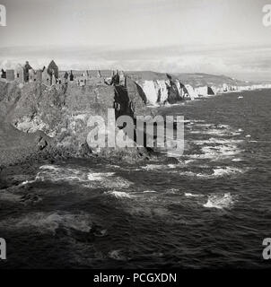 1950, historische, die dramatischen Ruinen der mittelalterlichen Dunluce Castle auf den Klippen an der Küste des Atlantischen Ozeans, Co Antrim, Nordirland. Stockfoto