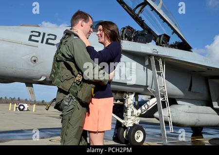 VIRGINIA BEACH, Virginia (31. 18, 2012) Leutnant Taylor Rives, zu Strike Fighter Squadron (VFA) 103, mit seiner Frau während einer homecoming Feier für das Geschwader vereint zugewiesen ist. VFA-143, Teil der Carrier Air Wing (Cvw) 7, kehrt zu Naval Air Station Oceana nach einem sechsmonatigen Einsatz in den USA am 5. und 6 Flotte Verantwortungsbereiche Unterstützung der Operation Enduring Freedom, Maritime Security Operations und Theater Sicherheit Bemühungen um Zusammenarbeit. Stockfoto