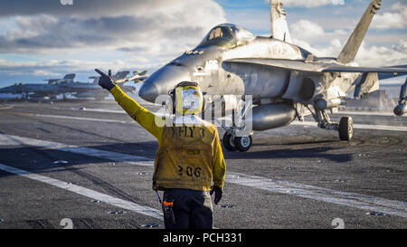 Pazifik (Nov. 9, 2017) der Luftfahrt Bootsmann Mate (Handling) 3. Klasse Vincent Sanchez der Pilot einer F/A-18C Hornet aus dem "Blauen Blasters" von Strike Fighter Squadron (VFA) 34 auf der Nimitz-Klasse Flugzeugträger USS Carl Vinson (CVN 70) Flight Deck. Carl Vinson ist die Teilnahme an einer Erhaltung Training in der Vorbereitung für eine bevorstehende Bereitstellung. Stockfoto