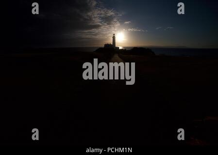 Silhouette der Leuchtturm (Leuchtturm) entlang der Turnberry, Ayrshire Küste neben dem Trump Turnberry Golf Course, mit dem Sonnenuntergang im Hintergrund. Stockfoto