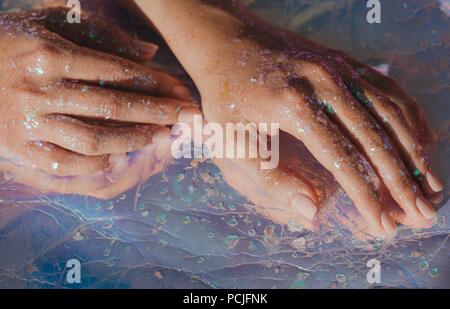 Menschliche Hände in Glitter abgedeckt Stockfoto