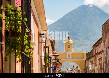 Antigua Guatemala, klassische Kolonialstadt mit berühmten Arco de Santa Catalina und Volcan de Agua hinter Stockfoto