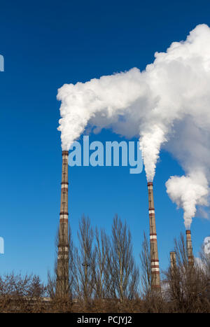 Die dicken Rauch steigt hoch aus dem industriellen Rohrleitungen. Verschmutzung der Umwelt durch Abfälle. Stockfoto