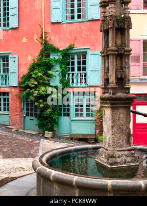 Street Scene von alten Gebäuden und eine Wasserpumpe in der Stadt Le Puy-en-Velay in der Auvergne-Rhone-Alpes in Frankreich. Stockfoto