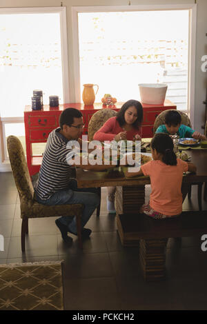 Familie mit Frühstück am Esstisch Stockfoto