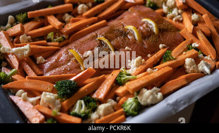 Rote fische Lachs mit süßen Kartoffeln, Broccoli und Blumenkohl für das Backen im Ofen. Gesundes Essen Stockfoto