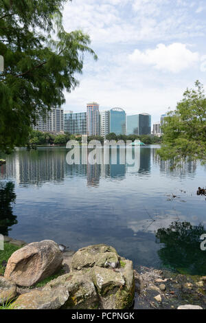 Blick auf die Skyline von Orlando, Florida, mit Reflexion über den Lake Eola in Lake Eola Park Stockfoto