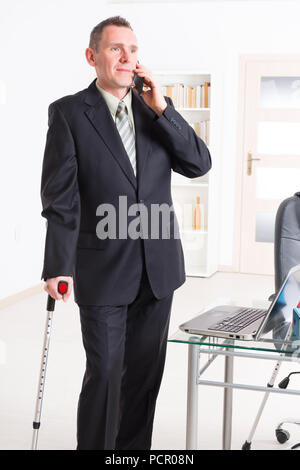 Kranker Geschäftsmann am Arbeitsplatz Stockfoto