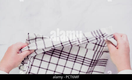 Klappbare Blck und weiß gemusterten Papier Handtücher auf Marmor Oberfläche. Stockfoto