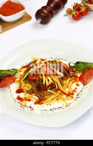 Urkish Fleisch Kebab mit Joghurt und Pommes Frites - cokertme Kebabi Stockfoto