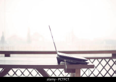 Holztisch auf der Veranda office laptop Internet moderne Gadget kopieren. Lebensstil die Landschaft Platz zum Arbeiten Stockfoto