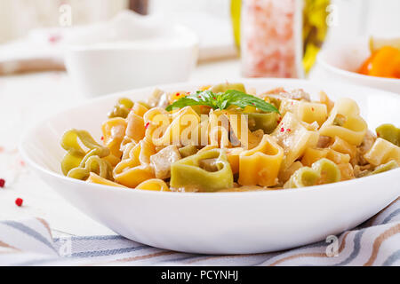 Cremige Nudeln mit Huhn und Aubergine diente in tiefen Teller. Italienisches Essen. Stockfoto