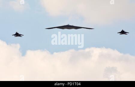 Northrop Grumman B-2 Spirit Stealth Bomber durch 2 McDonnell Douglas F-15 Kampfjets ein Flypast der RIAT 2018 begleitet Stockfoto