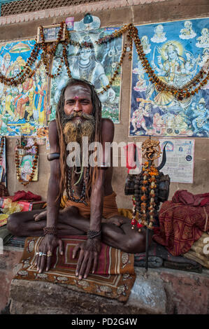 Ein Hindu Sadhu (heiliger Mann) auf dem Ganges ghat von Varanasi, Uttar Pradesh, Indien Stockfoto