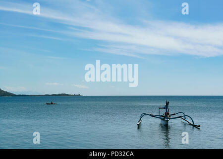 Lombok, Indonesien. Ein Fischerboot ruht in den Ozean. Stockfoto