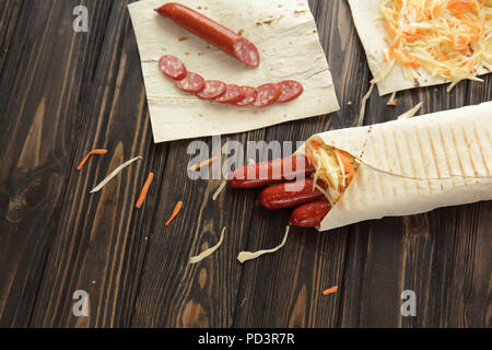 Geräucherte Wurst in Fladenbrot gewickelt. Foto mit Kopie Raum Stockfoto