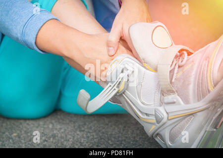 Verletzte skater sitzen und seine schmerzhaften Bein Holding Stockfoto