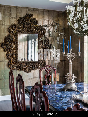Geschnitzte Folat Spiegel mit Bleikristall Baccarat Kronleuchter über Esstisch in London home Stockfoto