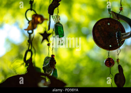 Mobile Skulptur mit glänzenden Elementen vor grünem Hintergrund Stockfoto