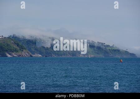 Meer Nebel über Klippen und das blaue Meer der Englischen Riviera, Torquay. Juni, 2018. Stockfoto