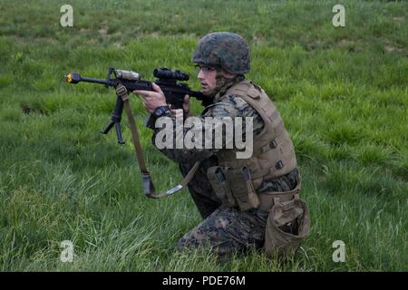 Us Marine Sgt. Derek R. Rush, platoon Sergeant mit Hauptsitz und Service Unternehmen, 6 Techniker, 4. Marine Logistik Gruppe, bietet Sicherheit für seine Platoon der Marines mit 6 ESB, 4. MLG und Commando mit 131 Commando Squadron Royal Engineers, britische Armee auf ein Dorf an der militärischen Operationen auf städtischen Gelände oder mout Struktur, während der übung Rote Dolch am Fort Indiantown Gap, Pa, 16. Mai 2018. Übung rote Dolch ist eine bilaterale Übung, die Marines die Möglichkeit, Taktiken, Techniken und Verfahren sowie bauen Arbeiten r Stockfoto