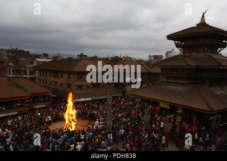 Bhaktapur, Nepal. 9 Aug, 2018. Devotees brennen ein Stroh Bildnis des mythischen Daemon Ghanta Karna während der Feierlichkeiten der Hindu festival Gathemangal in Bhaktapur, Nepal am Donnerstag, August 09, 2018. Nach Mythen Es wird angenommen, dass durch die Verbrennung der Dämon befreien, böse Geister und Krankheiten von Kindern. Credit: Skanda Gautam/ZUMA Draht/Alamy leben Nachrichten Stockfoto