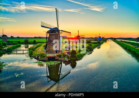 Luftaufnahme von traditionellen Windmühlen bei Sonnenuntergang in Kinderdijk, Niederlande. Dieses System der 19 Windmühlen wurde um 1740 erbaut und ist heute ein UNESCO herit Stockfoto