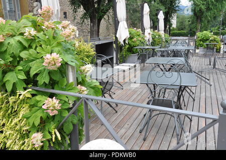 Open-air-Café im Garten mit leeren Möbel auf hölzernen Terrasse, auf der im Sommer rest Stockfoto