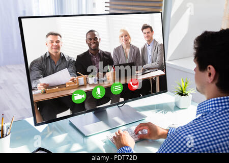 Geschäftsmann Videokonferenzen mit seinen Kollegen auf dem Computer am Arbeitsplatz Stockfoto