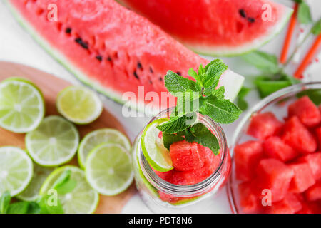 Scheiben Wassermelone und Kalk in einem Behälter mit Wasser zu füllen. Stockfoto