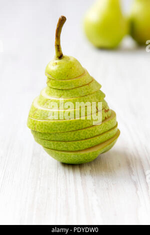 In Scheiben geschnitten Birne auf weissem Holztisch, Nahaufnahme. Von der Seite. Selektive konzentrieren. Stockfoto