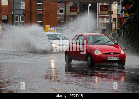 Liverpool, Großbritannien. 12 August, 2018. UK Wetter. Autos fahren durch Überschwemmungen auf Smithdown Road, Liverpool, 15 nach dem sintflutartigen Regen die Straße überflutet. Credit: Ken Biggs/Alamy Leben Nachrichten. Stockfoto