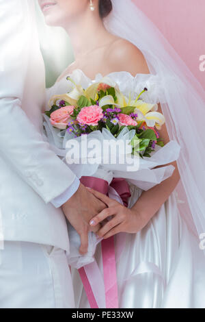 Paar hält einen Blumenstrauß mit einem glücklichen Hochzeitstag ist das Symbol der Liebe. Stockfoto