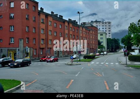 Eine typische Straßenszene, Brick Rotes Gebäude, Friseursalon Karin Durnthaler, Alpen Gebirgszüge im Hintergrund, Innsbruck, Österreich, Europa Stockfoto