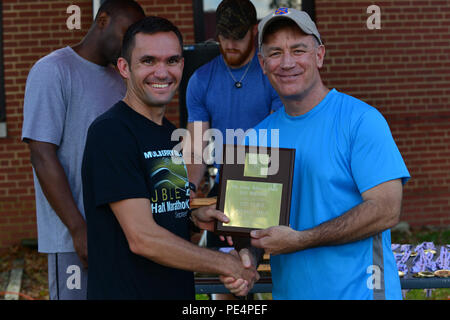 U.S. Army Colonel William S. Galbraith, 733Rd Mission Support Group Commander, rechts, Awards den ersten Platz in der Gesamtwertung männlichen Mulberry Insel Halbmarathon Plakette zu Kapitän Bryce Livingston, 7 Sustainment Brigade terminal Operations Officer, am Fort Eustis, Virginia, Sept. 19, 2015. Livingston beendete nicht nur die erste in seiner Kategorie, aber im Rennen mit einer Zeit von 1:13:28. (U.S. Air Force Foto: Staff Sgt. Natasha Stannard/Freigegeben) Stockfoto