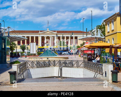 Plateia Korai Platz mit der U-Bahn U-Bahn Station Eingang in den Vordergrund und der Nationalen und Kapodistrias-Universität Athen im Hintergrund. Athen. Stockfoto