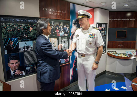 151002-N-IN 729-041 Yokosuka, Japan (Okt. 2010) 2, 2015) Kapitän Christopher Schraube, rechts, kommandierender Offizier der US-Marine ist nur Vorwärts - bereitgestellt Flugzeugträger USS Ronald Reagan (CVN 76), schüttelt Hände mit Hirofumi Nakasone, Mitglied des Hauses der Räte, während einer Tour an Bord Ronald Reagan. Ronald Reagan und Carrier Air Wing (Cvw) 5 Stellen eine Bekämpfung bereit, Kraft, schützt und verteidigt die kollektive maritime Interessen seiner Verbündeten und Partnern in der Indo-Asia-Pazifik-Region. (U.S. Marine Foto von Mass Communication Specialist 3. Klasse Ryan N. McFarlane/Freigegeben) Stockfoto