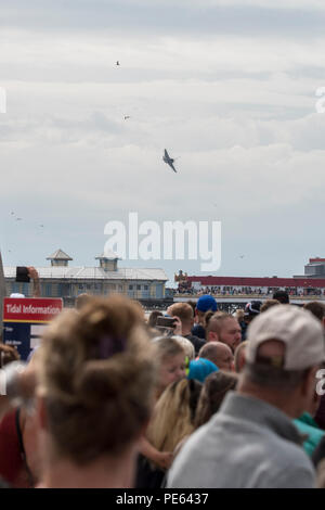 Blackpool, Großbritannien. 12. August 2018 - Menschenmassen versammeln die Blackpool Airshow zu sehen, einschließlich einer Leistung durch die RAF Red Arrows. Die roten Pfeile flogen vor dem Hintergrund des aufkommenden Sturm und durchgeführt für eine Menge von zig Tausend entlang der Promenade in Blackpool. Credit: Benjamin Wareing/Alamy leben Nachrichten Stockfoto