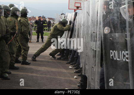 Deutsche Soldaten der multinationalen Battle Group-East Forward Command Post als widerspenstige Randalierer in einer Menschenmenge riot control Übung während des Betriebs Stonewall, 16. Okt. 2015, außerhalb der Bill Clinton Sportzentrum in Ferizaj, Kosovo zugewiesen. Betrieb Stonewall war eine kombinierte Notfalltraining Veranstaltung, die eine Masse riot control Situation übernommen, die von der Polizei des Kosovos und KFOR-Soldaten hielten zu MNBG zugeordnet - E. Die Übung mehr als 350 Mitarbeiter aus über mehrere Agenturen integriert als eine Möglichkeit, ihre Fähigkeit, eine sichere Umwelt durch das combin zu Praxis Stockfoto